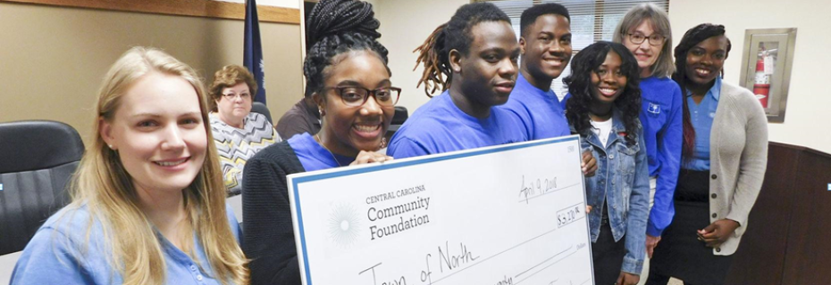 The North Mayor’s Youth Council is comprised of honor roll students from North High School who are committed to improving the town. With the group’s help, North recently received a $3,270 from the Central Carolina Community Foundation to beautify an intersection in the town. Pictured with oversized copy of the check are, from left, Cherise Arrendale of the CCCF; Mayor’s Youth Council members Brianna Byrd, Daiquel Houser, Patrick Mack and Nireon Fields; Mayor Patty Carson; and Jamesha Shackerford of CCCF.