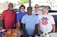 Clarence Donaldson, North Councilmembers Deborah Cook and Daniel Jackson, Suzanne Reed, and Savannah Reed volunteer for the Christmas at the North Pole concessions to raise money for that event during the fireworks in North on July 4th.