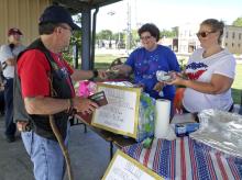 William Bramlett buys a hot dog from North Council woman Deborah Cook and Suzanne Reed, the chairman for the North Christmas Committee. Reed explained that all proceeds from the sale of hot dogs, drinks and chips will be donated to the 2018 North Christmas celebration.